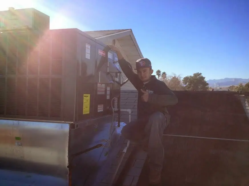 HVAC technician performing HVAC Inspection on a rooftop unit in River Ridge